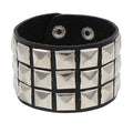 Black PU leather cuff covered in three rows of silver pyramid studs on a wide band.