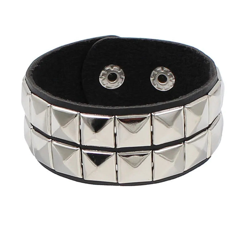 Black PU leather cuff lined with two rows of silver pyramid studs.