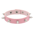 Slim pink PU leather cuff with a single row of silver cone spikes.