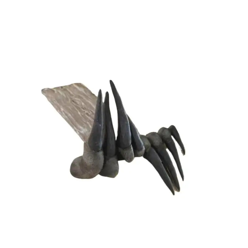 Dark grey devil claw bookmark with long talons gripping a book page