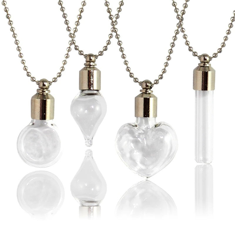 Clear glass vial pendants filled with red liquid on silver ball chains, shown against a white background.