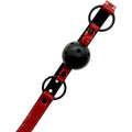 Black breathable ball gag with a perforated hollow ball on an adjustable red and black PU leather strap with O-rings and buckle.