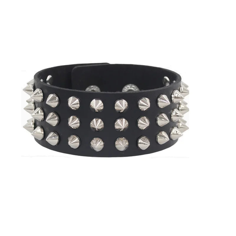 Black PU leather cuff set with three rows of pointed silver cone spikes on a wider band.