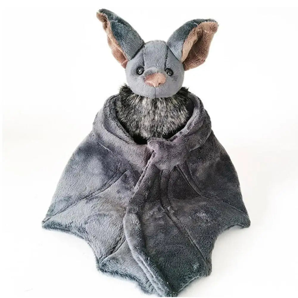 A soft grey bat plush with big pointed ears, a fuzzy tummy, and folded wings that drape down like a little cape.