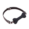 Black silicone bone-shaped gag on an adjustable black PU leather strap with red stitching, O-rings and buckle.