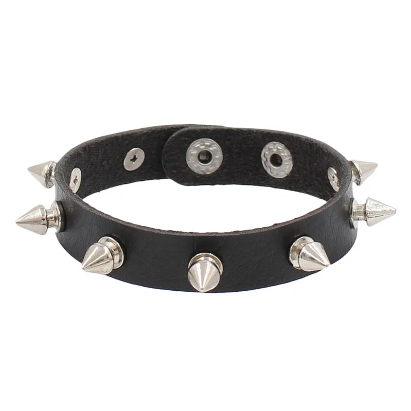 Slim black PU leather cuff with a single row of tall silver cone spikes.